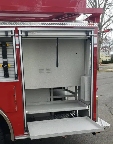 Open side compartment showing empty shelf bay with roll-up door raised