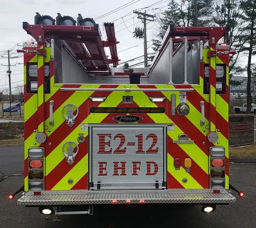 Rear view showing red-and-yellow chevrons and raised unit lettering