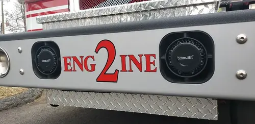 Body side close-up showing raised engine lettering and side panel trim