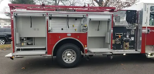 Driver-side profile showing pumper body and rear wheel area