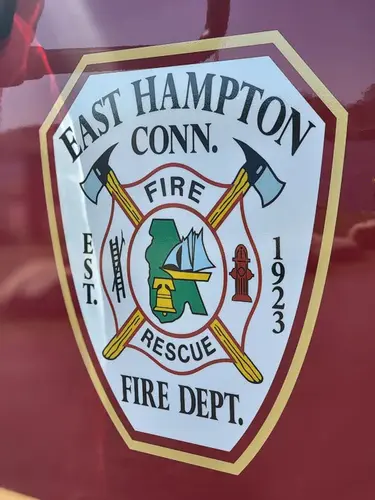Cab door close-up showing shield-style fire department crest