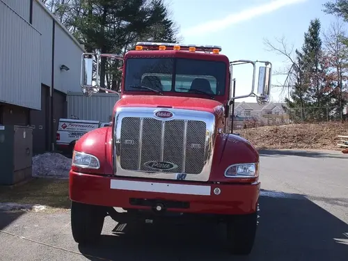Front exterior view showing grille, bumper, and warning lights