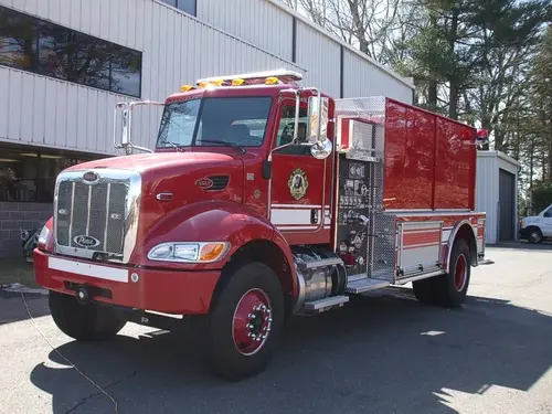Front-left exterior view showing bumper, cab, and tank body
