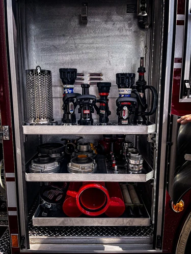 Open side compartment showing stacked bins and equipment containers