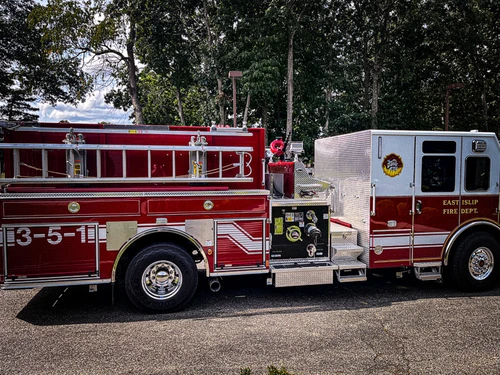 Driver-side profile view showing pumper body and rear wheel area