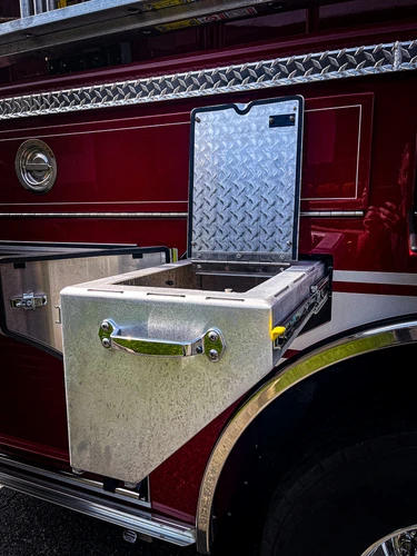 Open side compartment showing pull-out tray above rear wheel arch