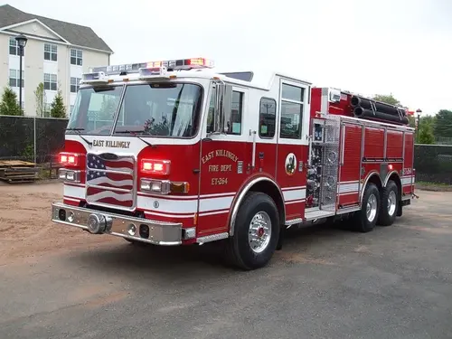 Front left exterior view of the tanker-pumper with triple rear axle, roof lights, and pump panel area visible.