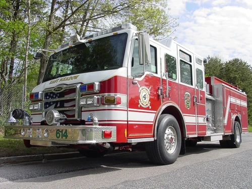 Pumper front-left exterior view showing enclosed cab and side compartments