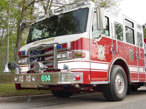 Front-left close view showing bumper, grille, and cab corner