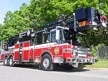Wide front-right thumbnail view of the tower ladder parked roadside.
