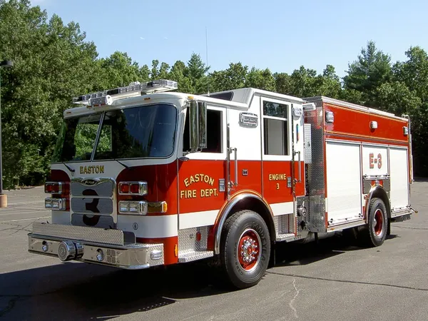 Pumper front-left exterior view showing enclosed cab and side compartments