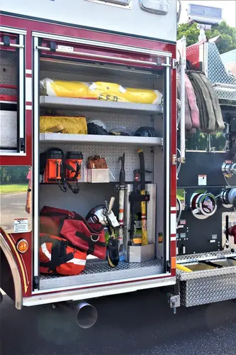 Open side compartment showing rescue tools and shelf bins