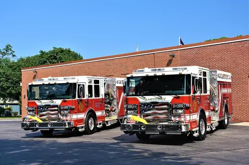 Station lot view showing two apparatus parked side by side