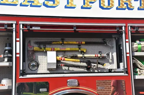 Open side compartment showing mounted hand tools and shelf storage