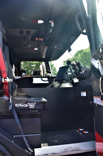 Cab interior side view showing front seats and center aisle
