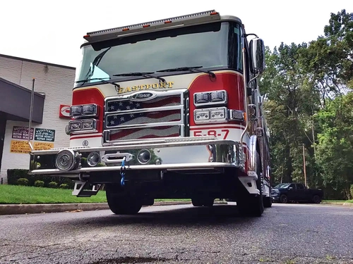 Pumper front-left exterior view showing chrome bumper, cab, and side body