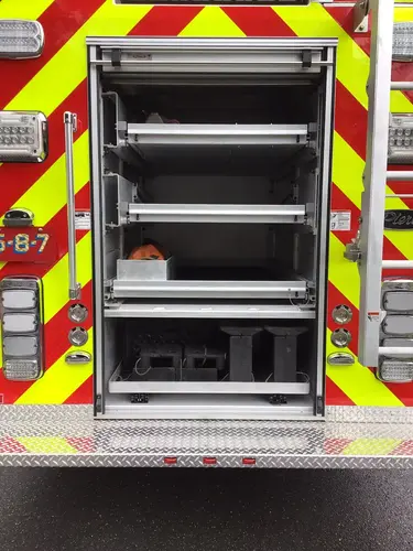 Rear compartment open showing slide-out shelves and storage trays