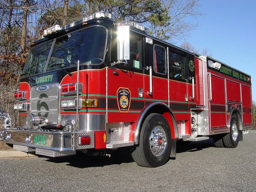 Pumper front-left exterior view showing enclosed cab and side compartments