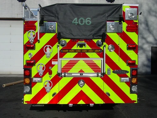 Rear view showing chevrons, hosebed cover, and rear warning lights