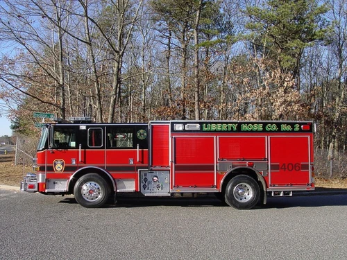 Driver-side profile view showing compartments, wheel area, and cab