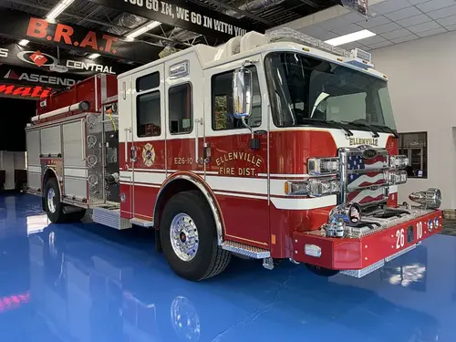 Pumper front-left exterior view showing grille, bumper, and cab