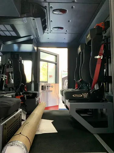 Cab interior rear view showing seat row and walkway to rear door
