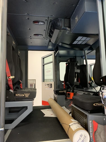 Cab interior side view showing rear seating area and stepwell