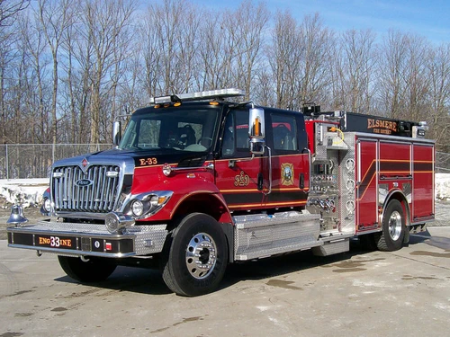 Pumper front-left exterior view showing grille, bumper, and side compartments