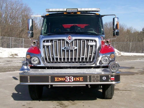 Front exterior view showing grille, bumper, and warning lights