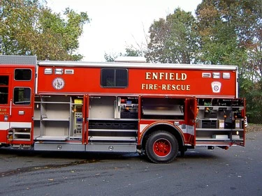 Passenger-side view with compartments open showing shelves and equipment bays