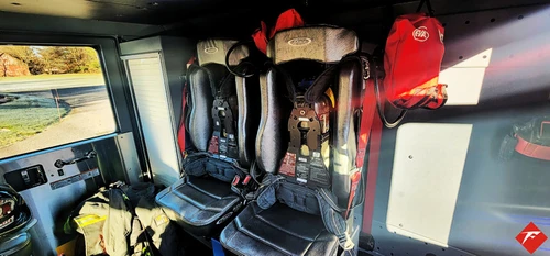 Cab interior view showing front seats and center aisle through crew area
