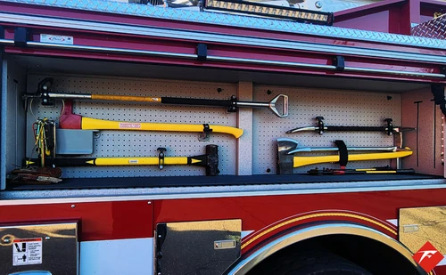 Open side compartment showing hand tools mounted in horizontal rack