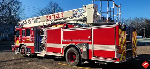 Driver-side profile view showing aerial ladder sections and side compartments