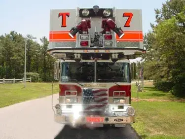 Front exterior view showing elevated ladder tip, grille, and bumper