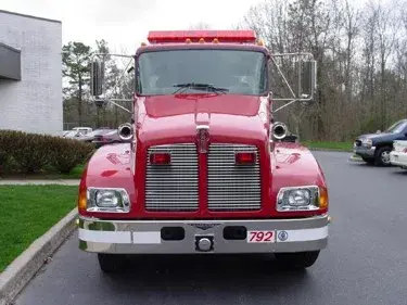 Head-on front view showing grille, bumper, and warning lights