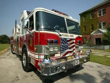 Front-left close view showing grille, bumper, and cab corner