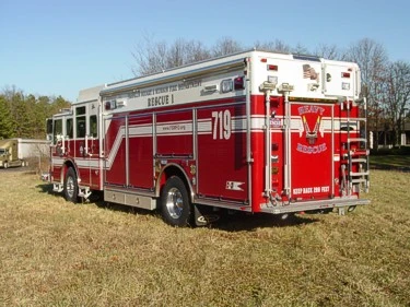 Rear-right exterior view showing heavy rescue rear panel and side striping