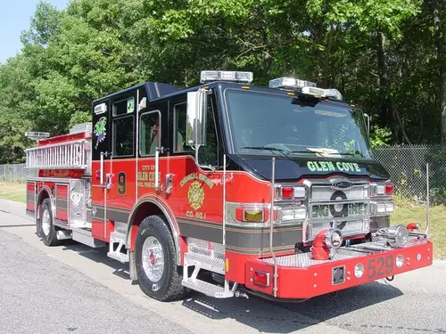 Front-right exterior view of an engine showing the cab, bumper, side compartments, and rear wheel area.