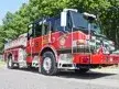 Wide front-right view of the engine parked roadside with full cab and side profile visible.