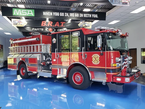 Pumper front-left exterior view showing grille, bumper, and enclosed cab
