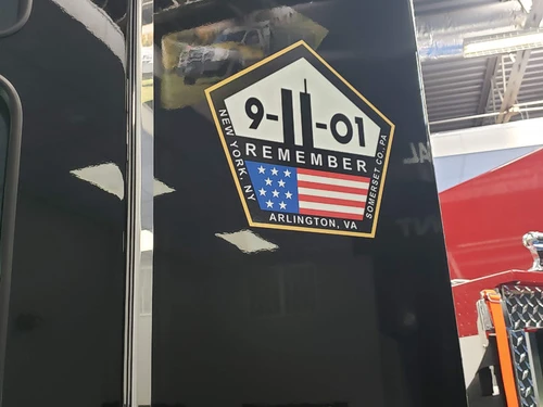 Body patch close-up showing memorial-style shield graphic on dark background