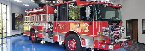 Pumper front-left exterior view parked inside apparatus bay