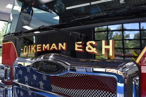 Front grille close-up showing company lettering and Pierce badge
