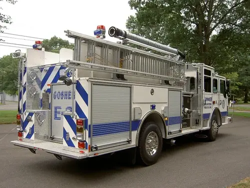 Rear-right exterior view showing ladder rack, rear body, and side compartments