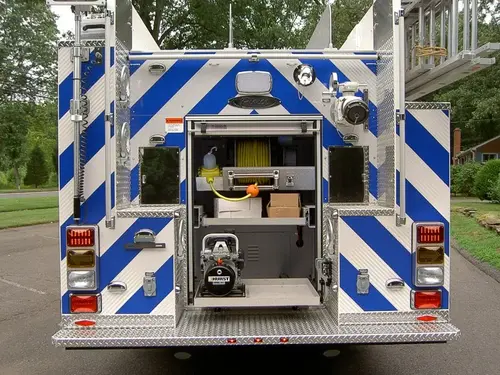 Rear view with compartment open showing tools and rear chevron striping