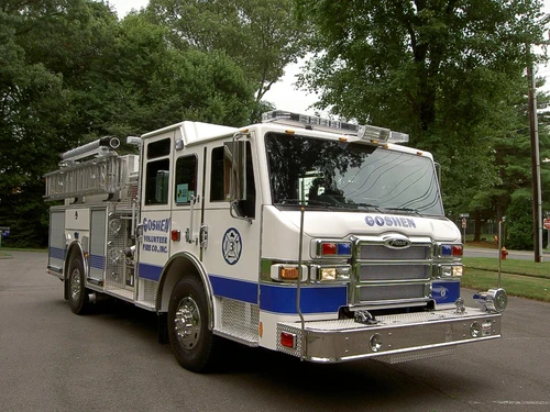 Front-left exterior view showing cab, bumper, and side body