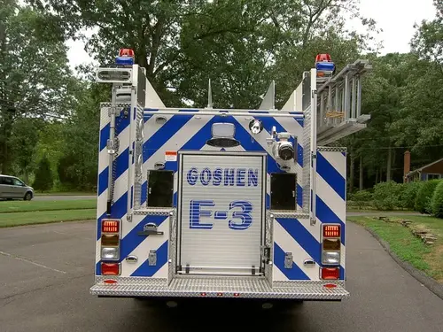 Rear view showing chevrons, rear roll-up door, and warning lights