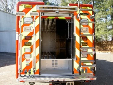 Rear view with rear compartment door open showing interior rescue storage bays
