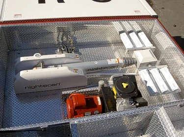 Top compartment view showing mounted light towers and equipment bins