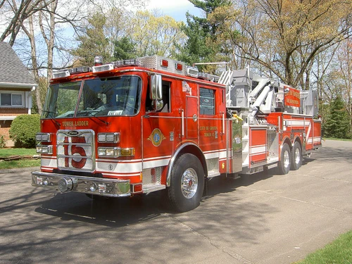 Tower ladder front-left exterior view showing enclosed cab and aerial sections